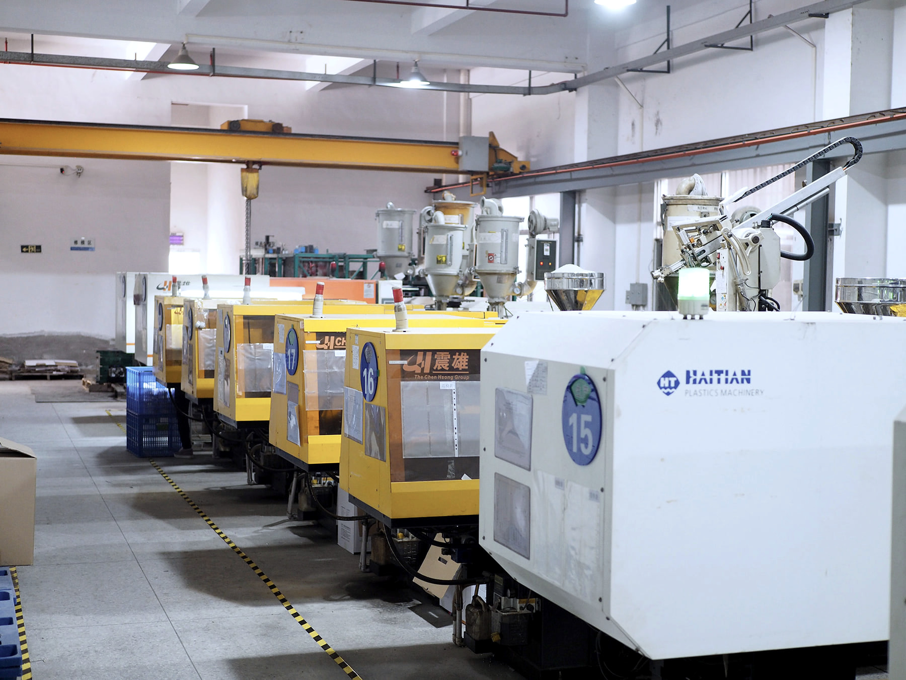 Rows of injection molding equipment supporting automated workshop operations.
