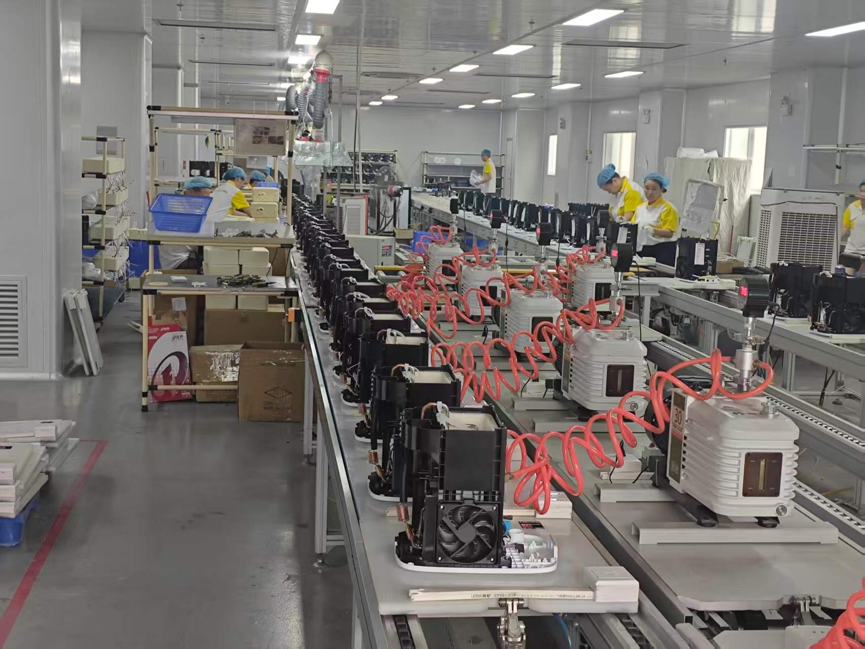 Refrigeration assemblies and vacuum stations extending along the in-house production line.