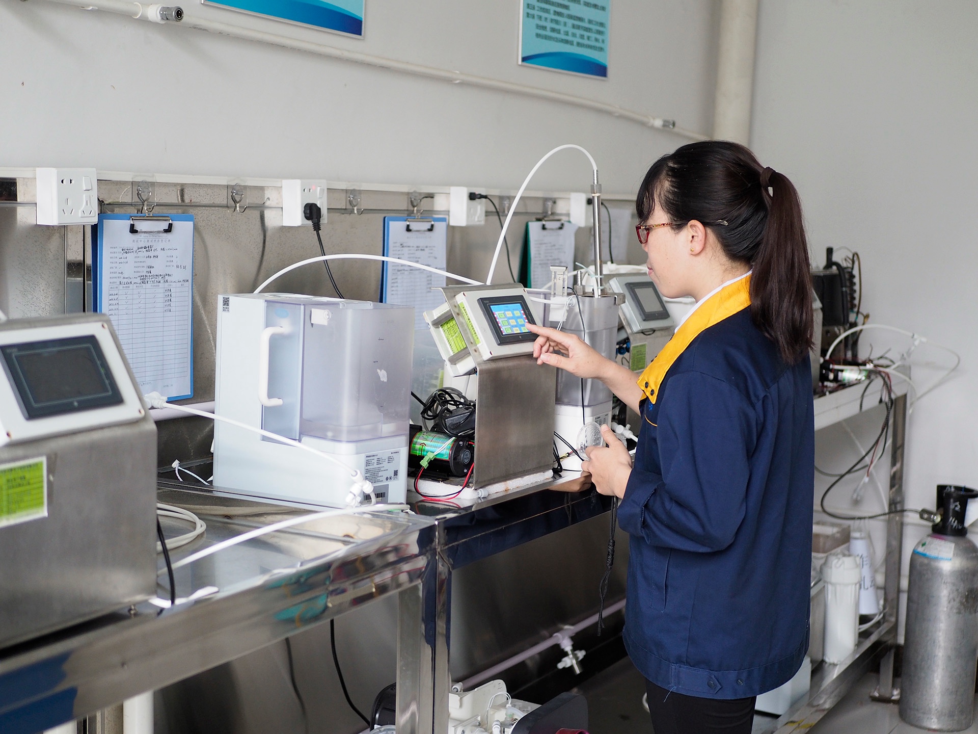 A laboratory technician operating water-system testing equipment.