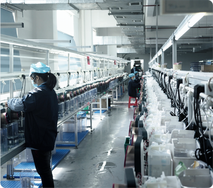 A technician monitoring rows of water appliances on a long-cycle test line.